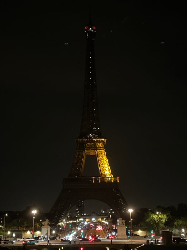 Eiffel Tower glows golden in Paris night scene