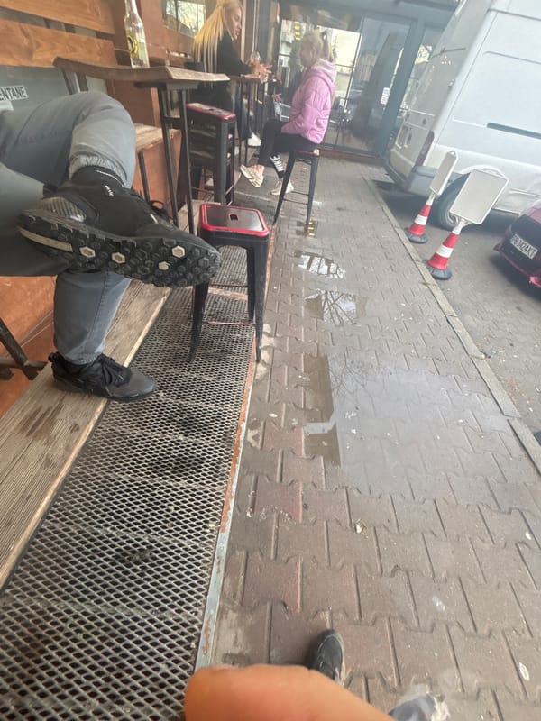 Person sits on bench in Plovdiv street scene