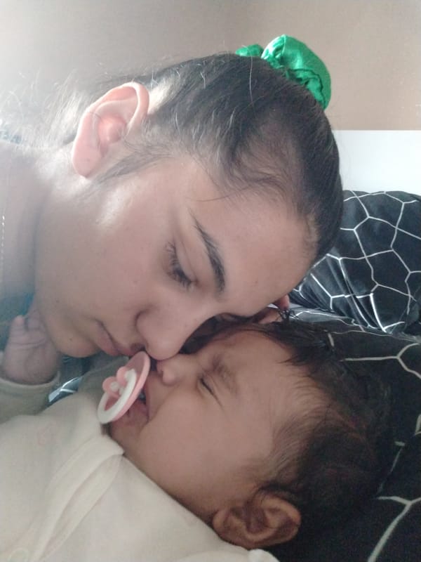 Morning caregiving moments between woman and baby documented indoors