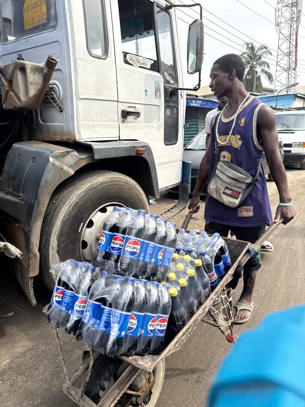 Man works with loaded handcart in Lekki, Lagos