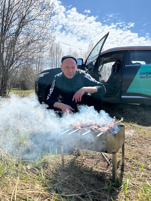 Man grills kebabs and brews tea outdoors in flooded area