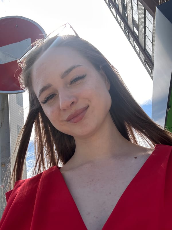 Selfie session outside apartment building in red dress