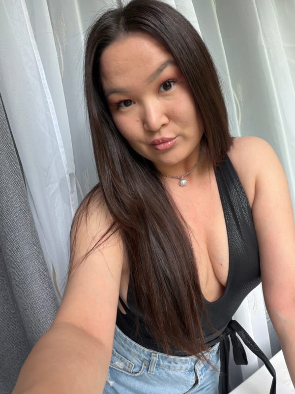 Woman takes selfie in black textured top