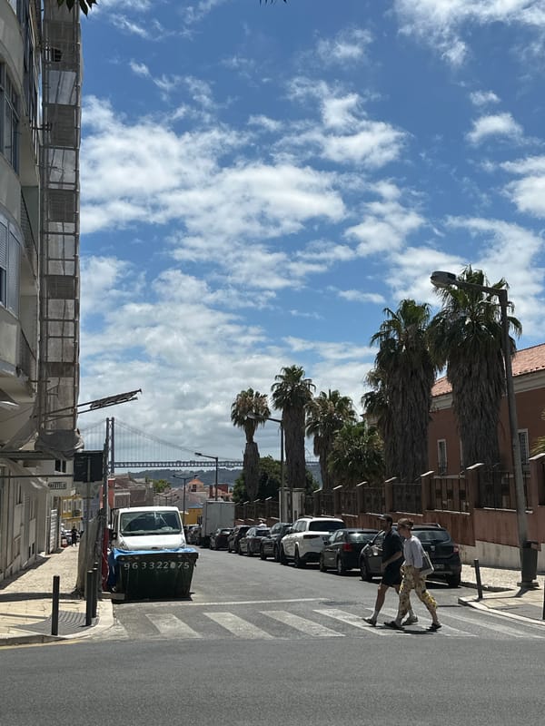 Two angles on a Lisbon street, green dumpster in frame