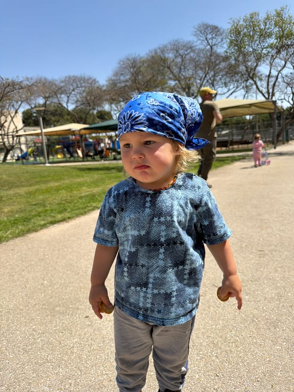 Child in blue bandana spotted on park path in Kiryat Bialik
