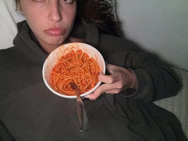 Person eats spaghetti while lying down in Acapulco bedroom