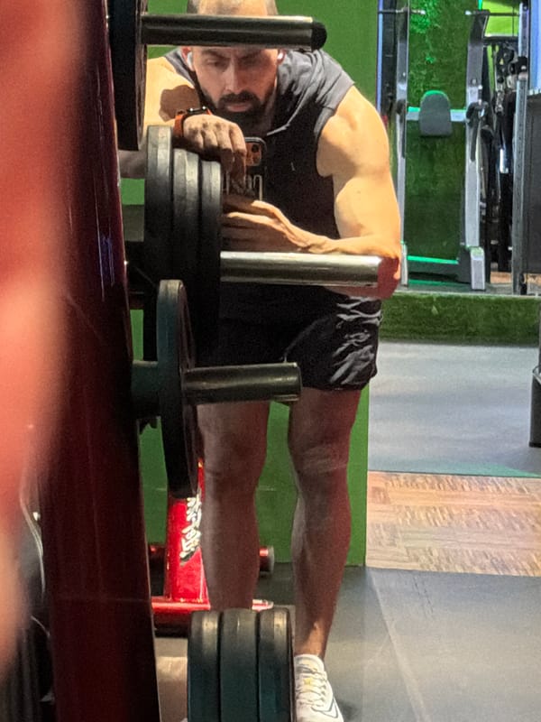 Man prepares barbell with weights at Plovdiv gym