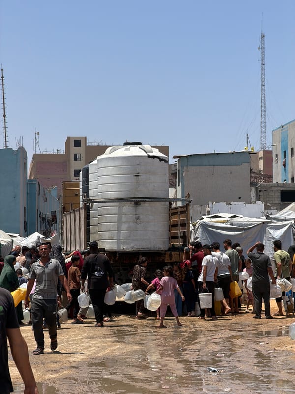Families collect water from trucks in Gaza City