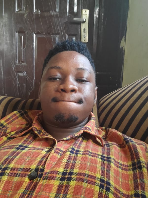 Person in plaid shirt rests in Mararaba, Nigeria