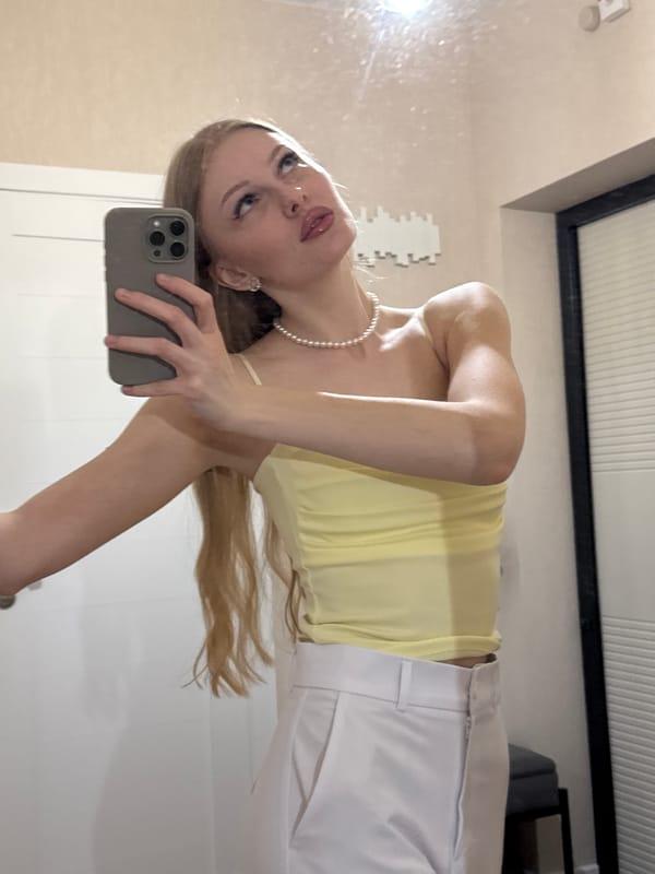 Mirror selfie session in Perm, yellow top and pearls