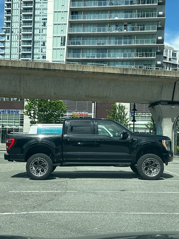 Construction worker operates boom lift at Coquitlam building site
