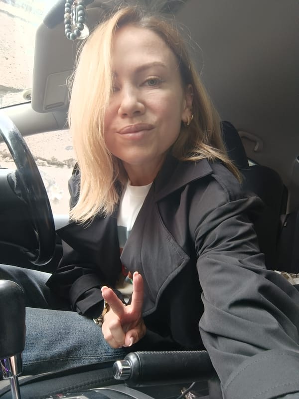 Woman takes selfie in car driver's seat, Naberezhnye Chelny