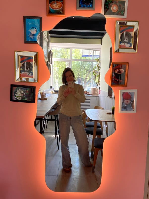 Woman takes mirror selfie in Chaikovsky cafe