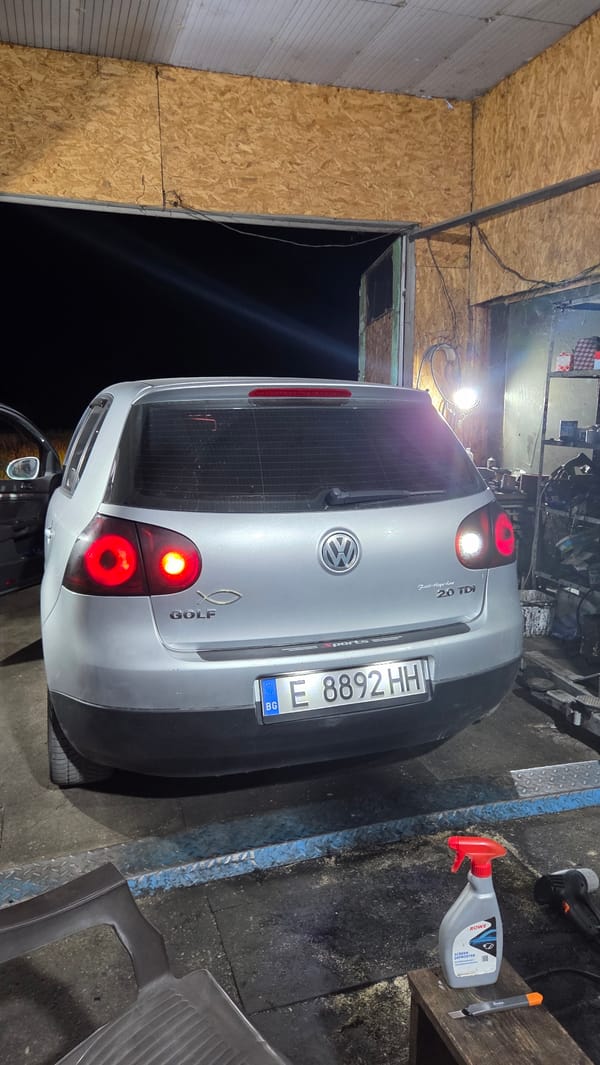 Silver VW Golf parked indoors, brake lights on