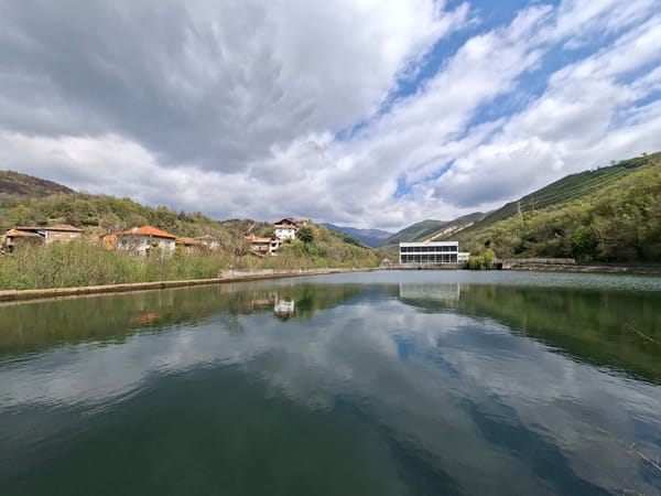 Witness documents calm urban waterway with modern building reflections
