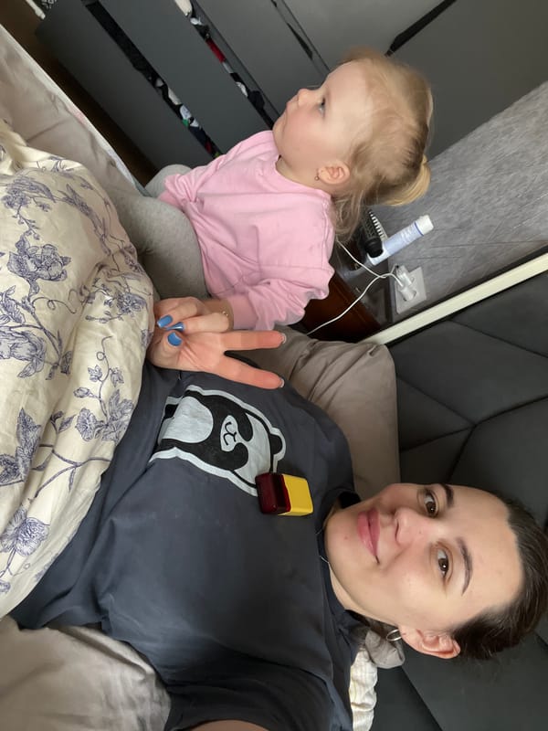 Mother and child share quiet moment in Leninakan bedroom