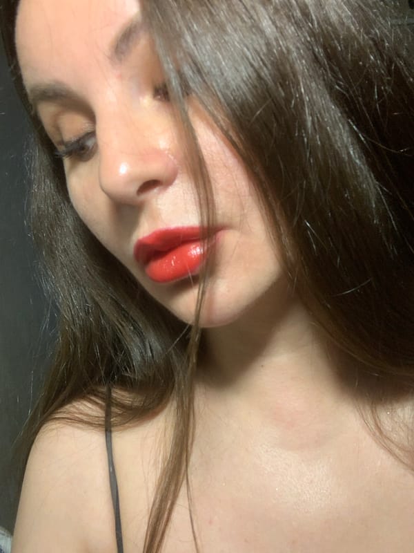 Woman documents red lipstick application for #kissChallenge social media content