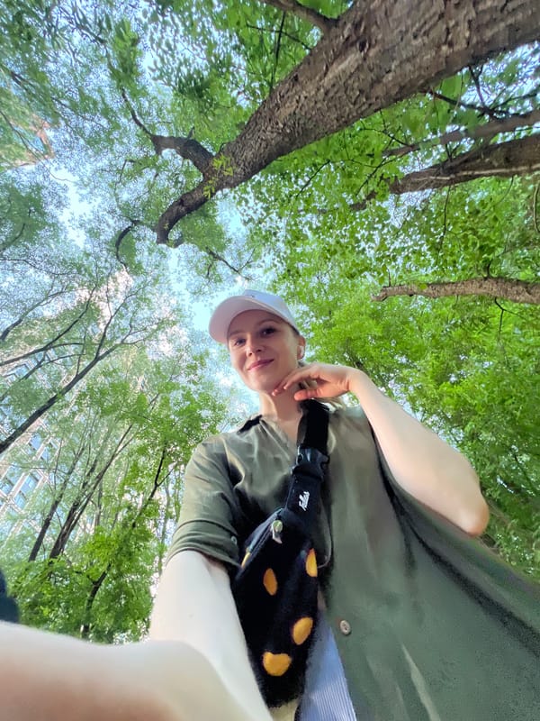 Person in white cap observed under trees in Khimki