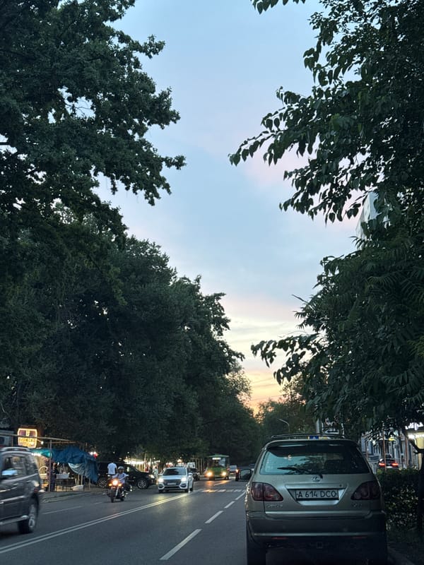 Evening drive through Almaty streets, captured from inside a Kia