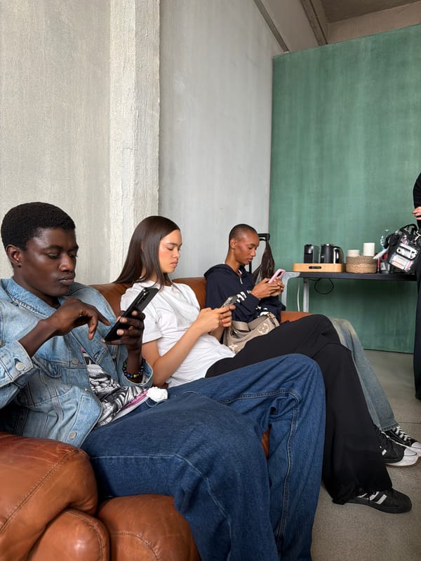 Four people relax on couch with smartphones in Milan