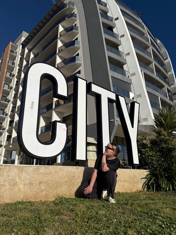 Tourists pose with letter sculptures in Bar, Montenegro