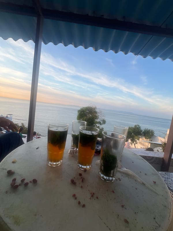 Sunset mint tea gathering captured at Tangier coastal cafes