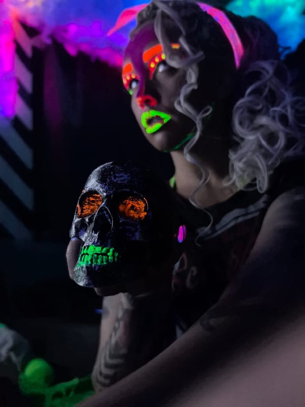 Neon makeup and glowing skulls at a UV party in Noviy