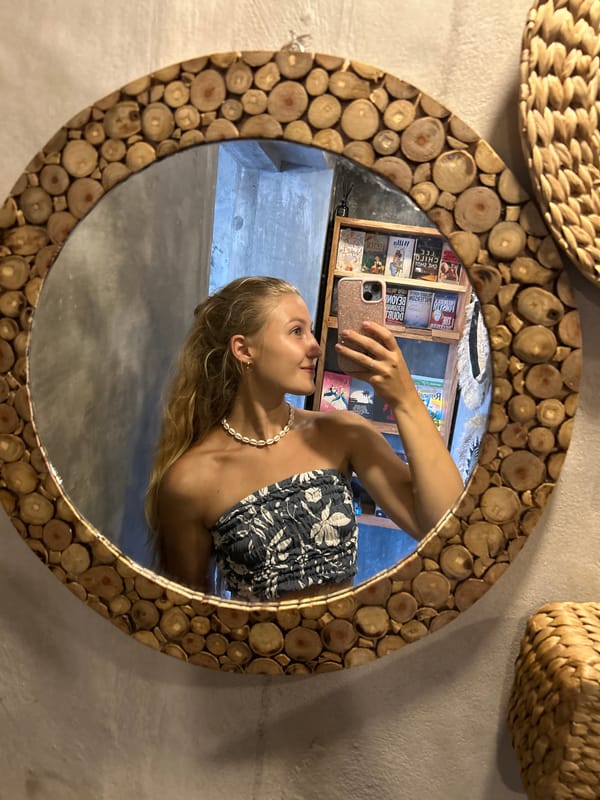 Woman takes mirror selfies at decorated Sukawati location