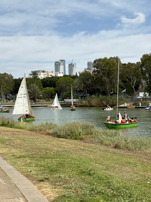 Recreational boats with passengers cruise Yarkon River in Tel Aviv