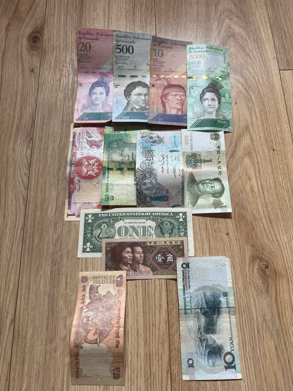 Foreign currency collection documented on wooden surface