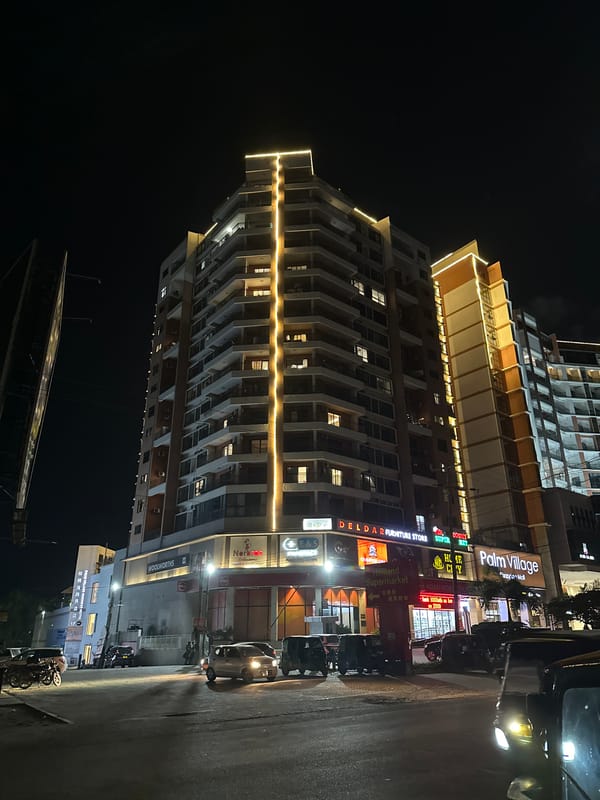 Dar es Salaam nightlife strip, neon lights and wet streets
