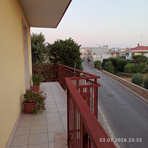 Dusk settles over a quiet residential neighborhood in Bitonto, Italy