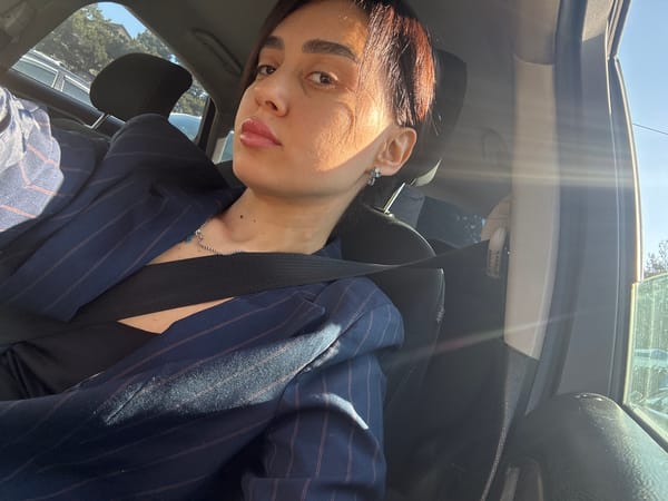Woman takes car selfies in Tbilisi parking lot
