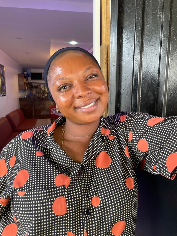 Woman celebrates with blue balloon across Jos, Nigeria