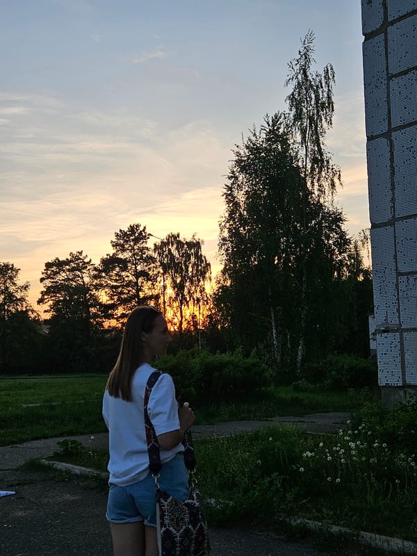 Woman enjoys spring flowers during sunset photoshoot in Chaikovsky