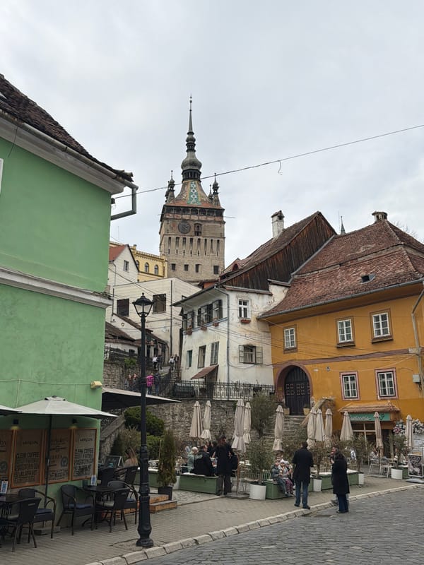 Tourist documents historic Sighișoara's medieval streets and landmarks