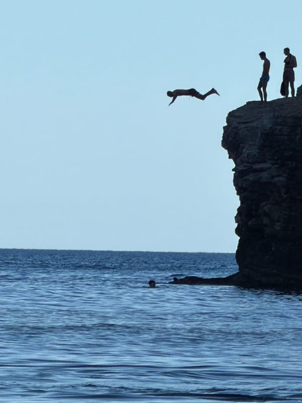 Cliff diving and swimming at a rocky Budva coastal spot