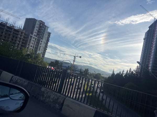 Vehicle journey through sunny Tbilisi passes construction sites