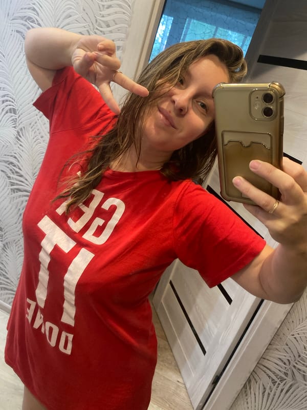 Mirror selfies at home in Noviy, red 'GET IT DONE' tee