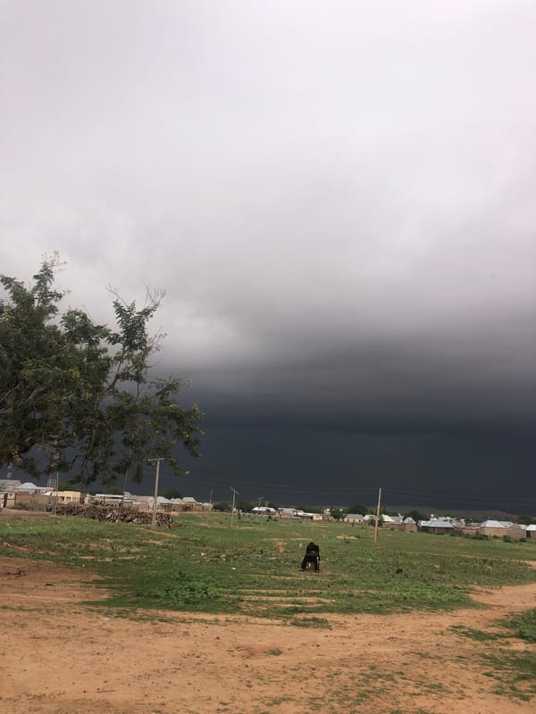 Woman poses for selfies as storm approaches Nigerian village
