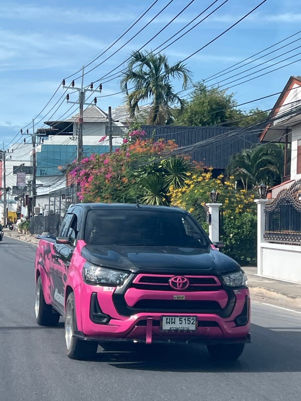 Pink-accented Hilux Revo cruising Ko Samui's wire-lined streets