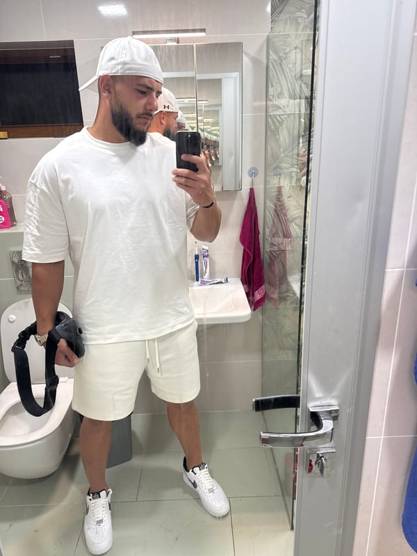 Mirror selfie session in a Sofia bathroom, all-white fit