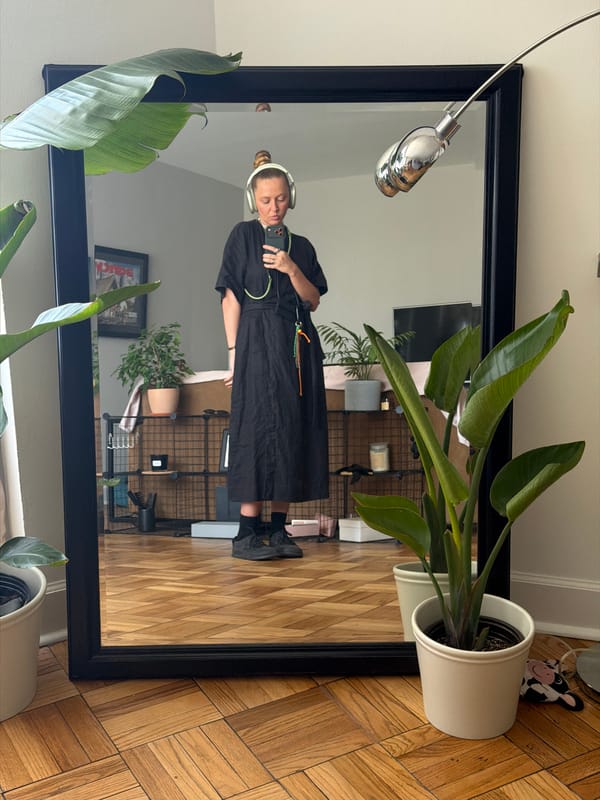 Person takes mirror selfie in black dress, Los Angeles