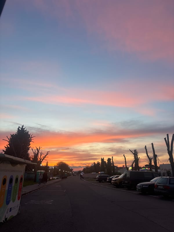 Vibrant sunset colors illuminate street scene in Pomorie, Bulgaria