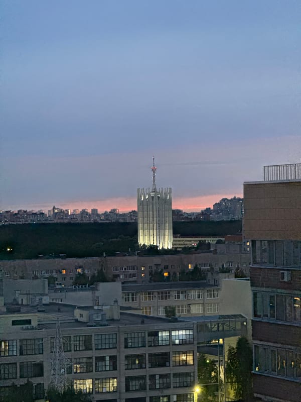 Sinyavino apartment blocks at dusk, windows beginning to glow