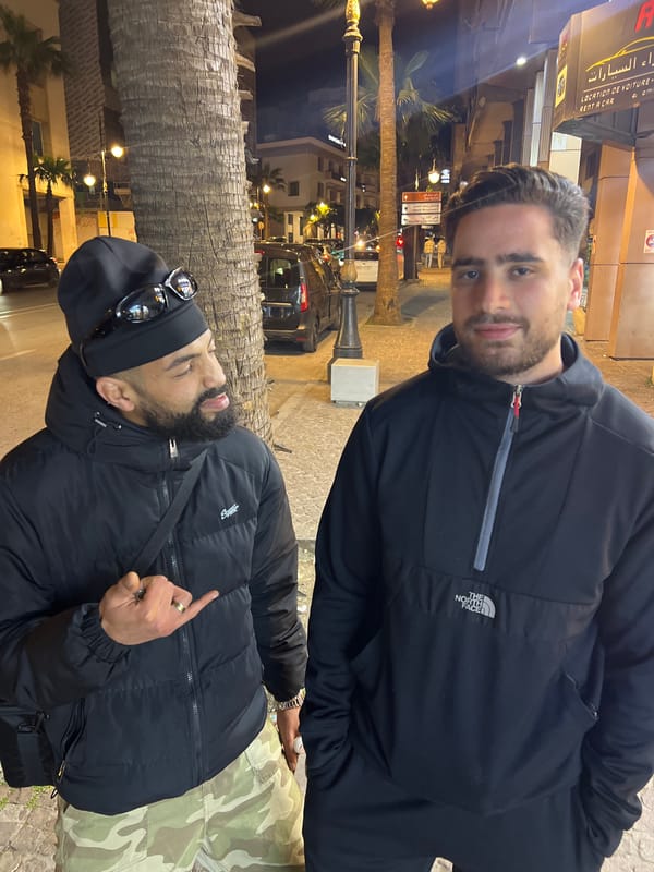Friends socializing on Tangier streets during evening hours