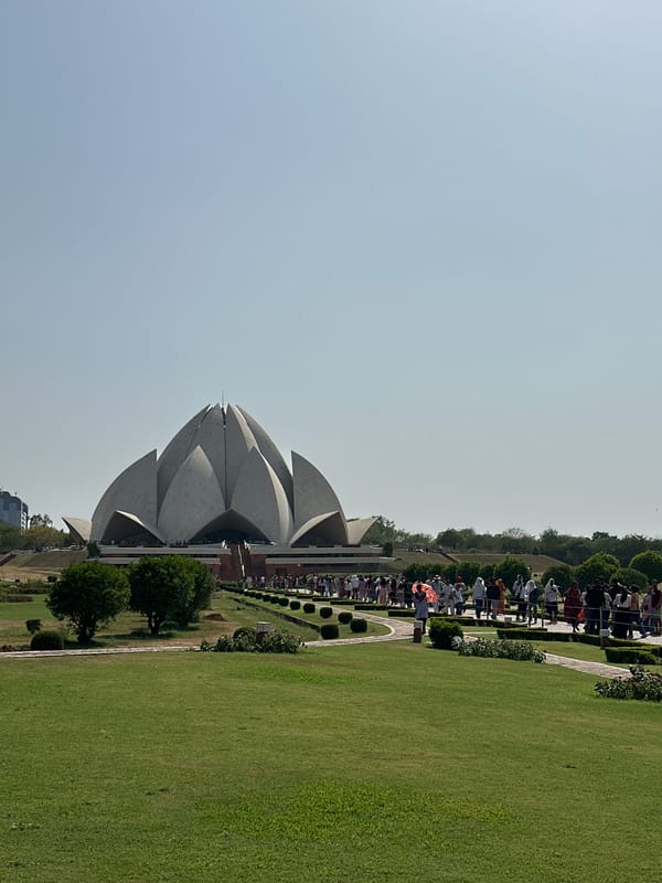 Visitors gather at Delhi's iconic Lotus Temple under clear skies