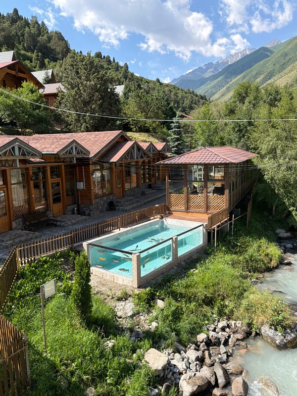 Mountain resort stop with river views and rustic architecture