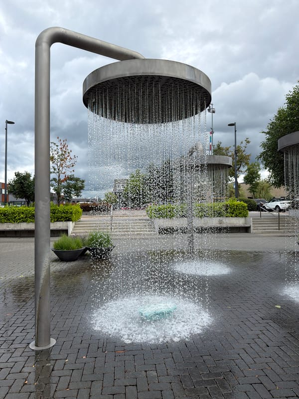 Vilnius plaza fountain installation rains water from oversized shower heads