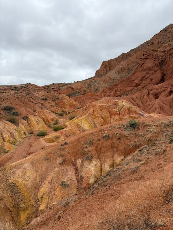 Tourist documents Fairytale Canyon rock formations in Tosor, Kyrgyzstan